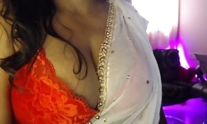 Torrid desi chick is having joy by demonstrating her youthfull melons to studs.