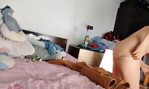 An amateur woman has fun trying on clothes that she cuts.