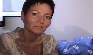 Short haired German nymph pleasing her furry vag with a fake penis