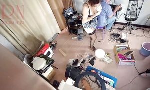 A bare maid is cleaning up in an silly IT engineer's office. Real camera in office. Sequence 1